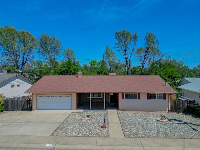 3140 Winding Way, Redding, CA 96003 - ranch-style house featuring a garage, fence, concrete driveway, and a porch