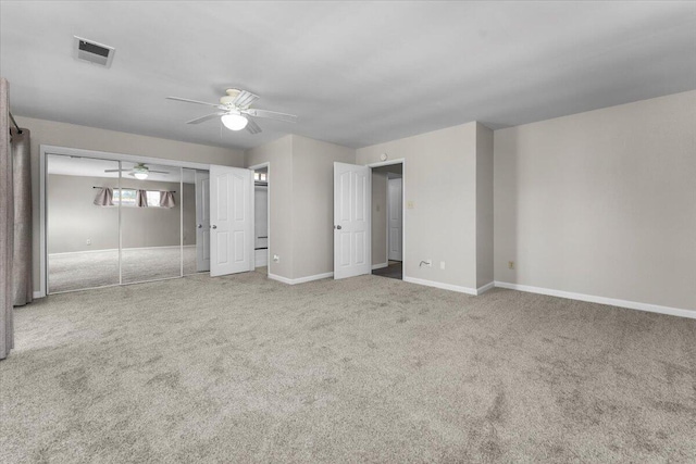 unfurnished bedroom featuring ceiling fan, carpet flooring, baseboards, and visible vents