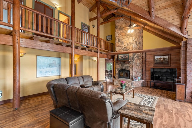 living room featuring a fireplace, wood-type flooring, high vaulted ceiling, and a ceiling fan