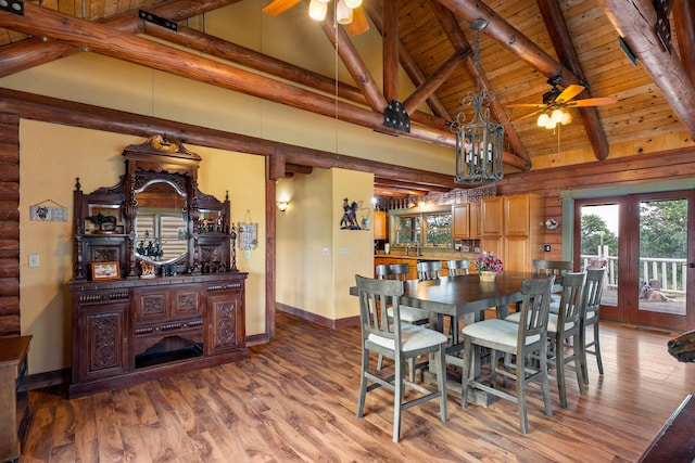 dining area with light wood finished floors, wood ceiling, a ceiling fan, and vaulted ceiling with beams