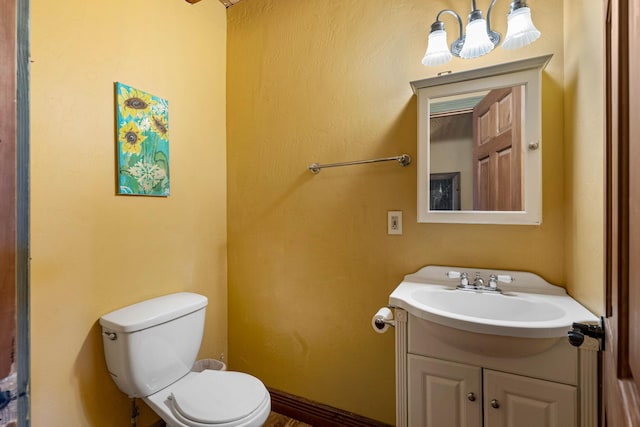 bathroom featuring toilet and vanity
