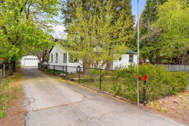 979 Lassen Ln, Mount Shasta, CA 96067 - obstructed view of property featuring an outdoor structure, fence, and a detached garage
