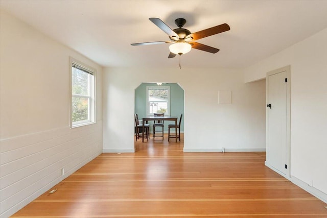 979 Lassen Ln, Mount Shasta, CA 96067 - unfurnished room featuring arched walkways, ceiling fan, baseboards, and light wood-style floors