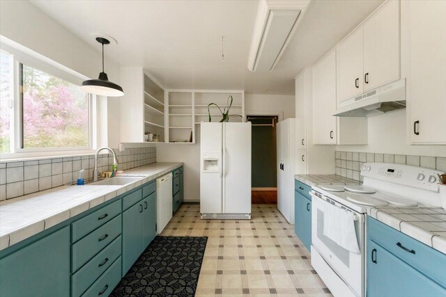 979 Lassen Ln, Mount Shasta, CA 96067 - kitchen with open shelves, white appliances, light floors, under cabinet range hood, and a sink