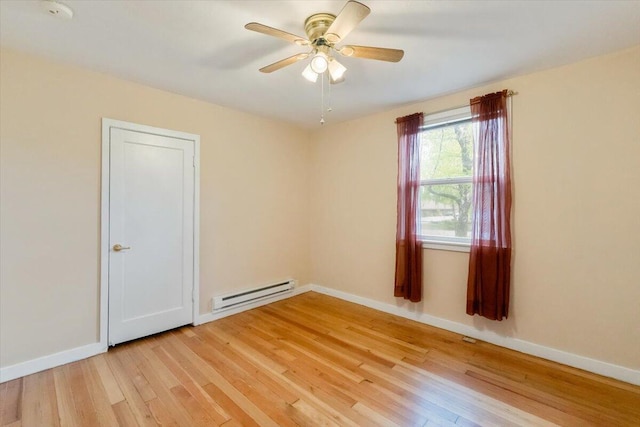 979 Lassen Ln, Mount Shasta, CA 96067 - empty room with a ceiling fan, baseboards, a baseboard heating unit, and light wood-style flooring