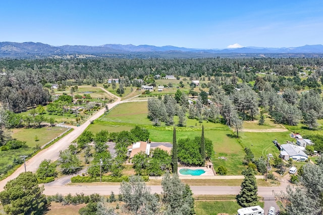 bird's eye view featuring a forest view and a mountain view