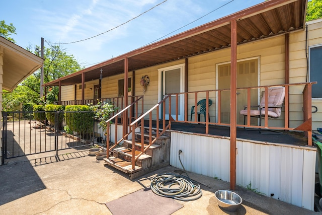 property entrance featuring a porch and fence