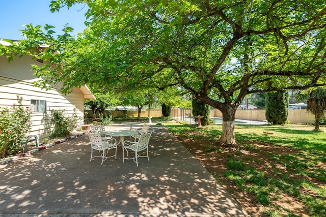 view of patio with outdoor dining area and a fenced backyard