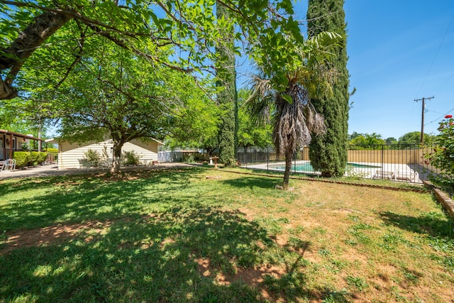 view of yard featuring fence and a fenced in pool