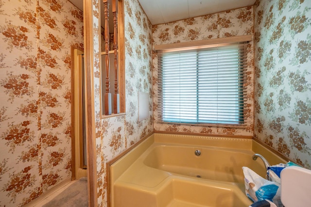 full bathroom with wallpapered walls and a bath