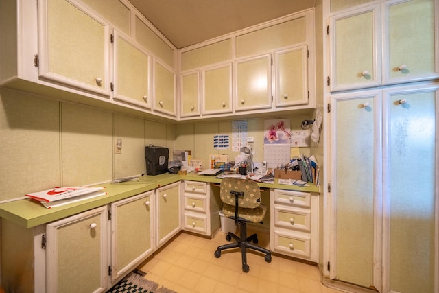 office with built in desk and light floors