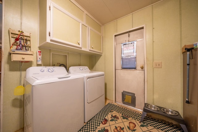 laundry area with cabinet space, light tile patterned floors, and independent washer and dryer