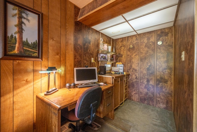 carpeted home office with wooden walls