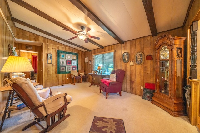 interior space with wood walls, a ceiling fan, lofted ceiling with beams, and carpet floors