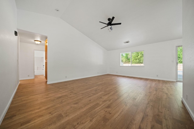 14556 Ryan Ln, Red Bluff, CA 96080 - unfurnished living room with visible vents, wood finished floors, baseboards, a ceiling fan, and vaulted ceiling