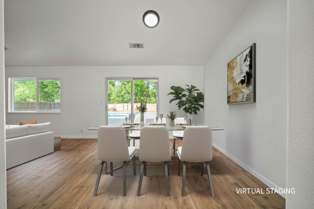 14556 Ryan Ln, Red Bluff, CA 96080 - dining space featuring visible vents, wood finished floors, a wealth of natural light, and vaulted ceiling