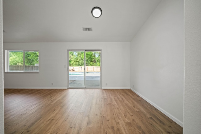 14556 Ryan Ln, Red Bluff, CA 96080 - spare room with a wealth of natural light, vaulted ceiling, wood finished floors, and visible vents