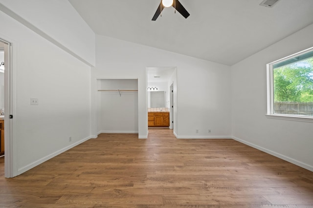 14556 Ryan Ln, Red Bluff, CA 96080 - unfurnished bedroom featuring a closet, ensuite bathroom, baseboards, light wood-style flooring, and vaulted ceiling