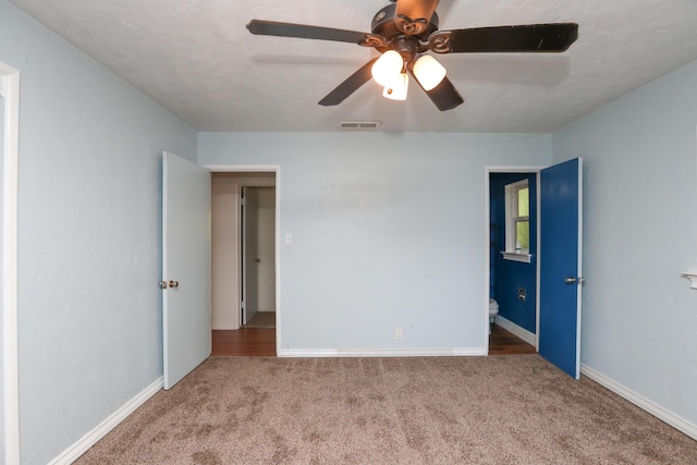 unfurnished bedroom with baseboards, carpet flooring, and visible vents