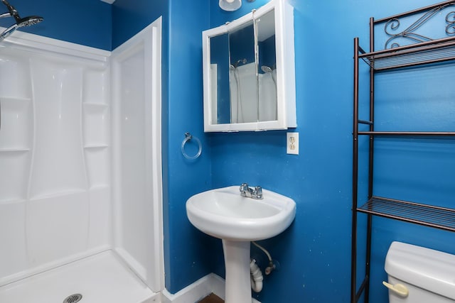 bathroom with toilet and a stall shower