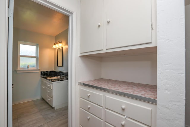 bathroom featuring vanity and baseboards