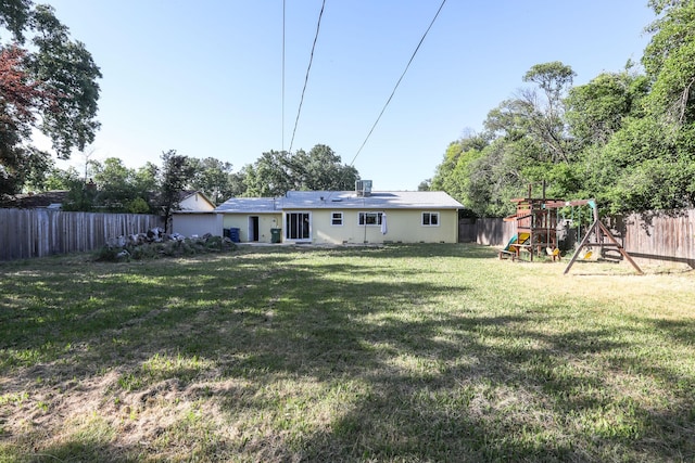 view of yard with a fenced backyard and a playground