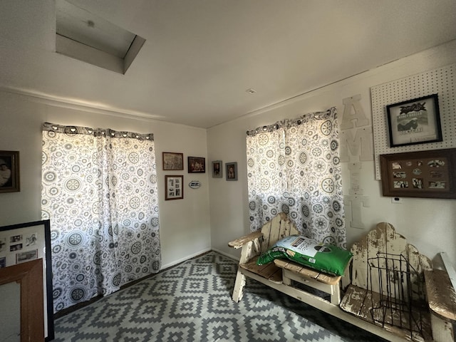 interior space featuring baseboards and attic access