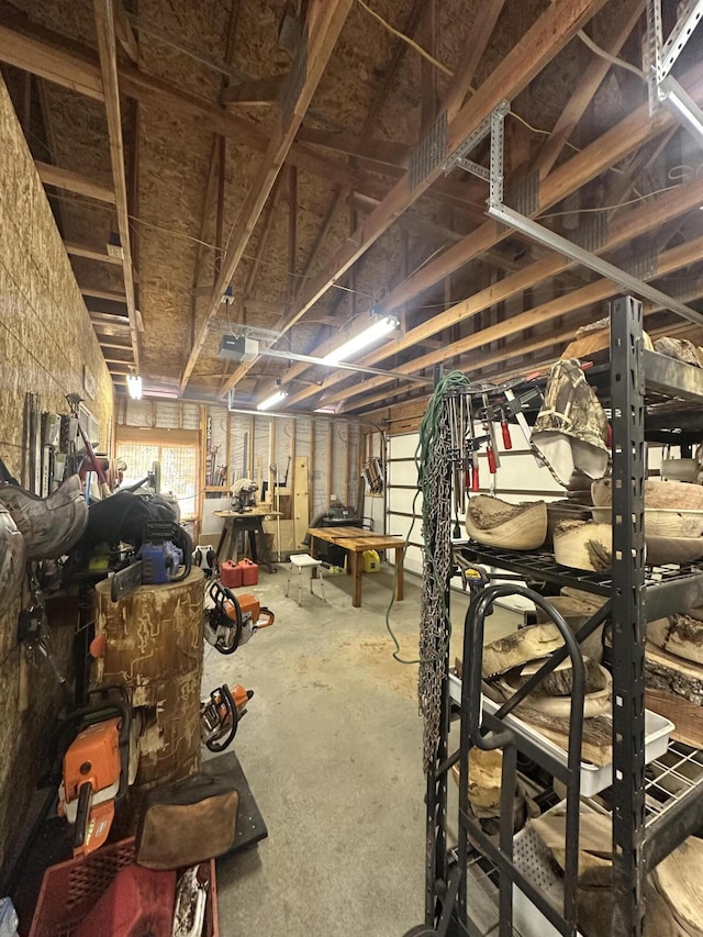 miscellaneous room with a workshop area and unfinished concrete floors