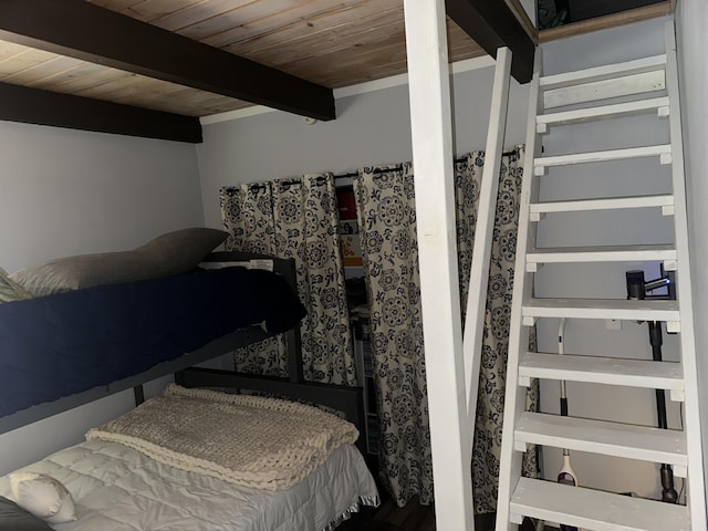 bedroom with beamed ceiling and wood ceiling