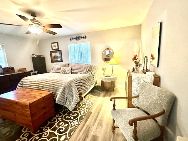 bedroom with ceiling fan and wood finished floors