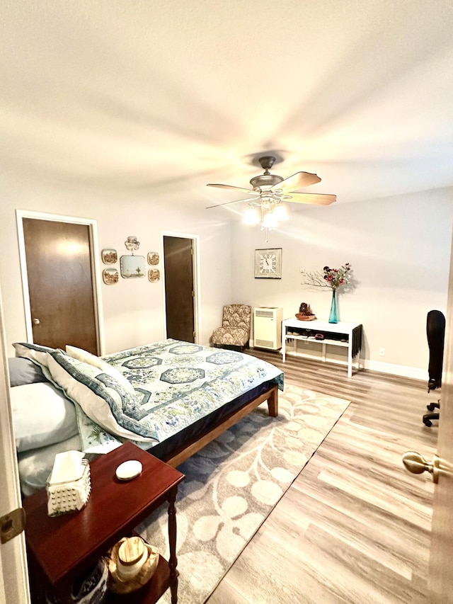bedroom featuring a ceiling fan and wood finished floors