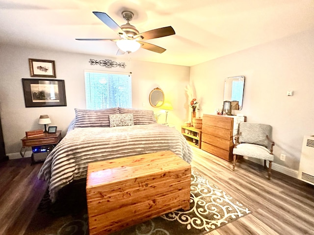 bedroom featuring baseboards, a ceiling fan, and wood finished floors