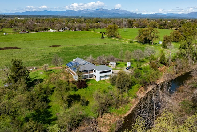 drone / aerial view featuring a mountain view and a rural view