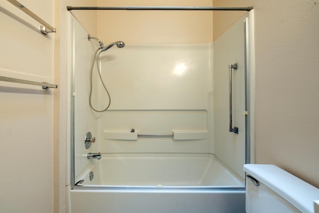 full bath featuring shower / bathing tub combination, a textured wall, and toilet