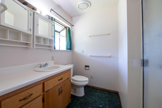 bathroom with toilet, baseboards, and vanity