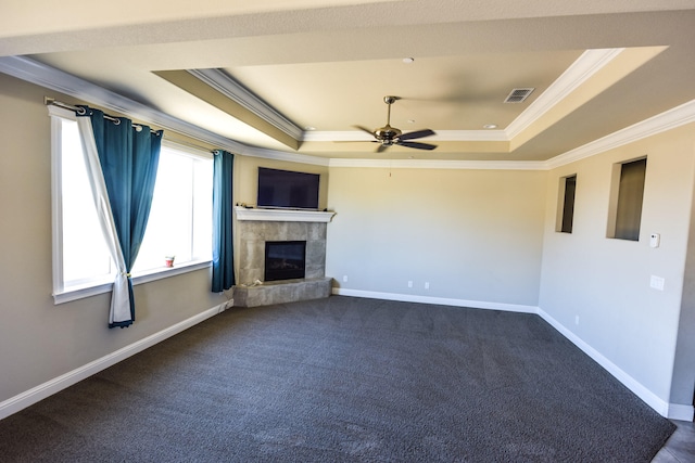 2876 Calaveras Ct, Redding, CA 96002 - unfurnished living room featuring a tray ceiling, ornamental molding, ceiling fan, a tiled fireplace, and baseboards