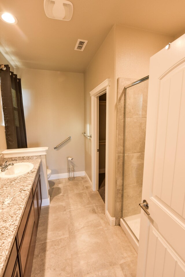 2876 Calaveras Ct, Redding, CA 96002 - bathroom with a shower stall, vanity, toilet, and baseboards