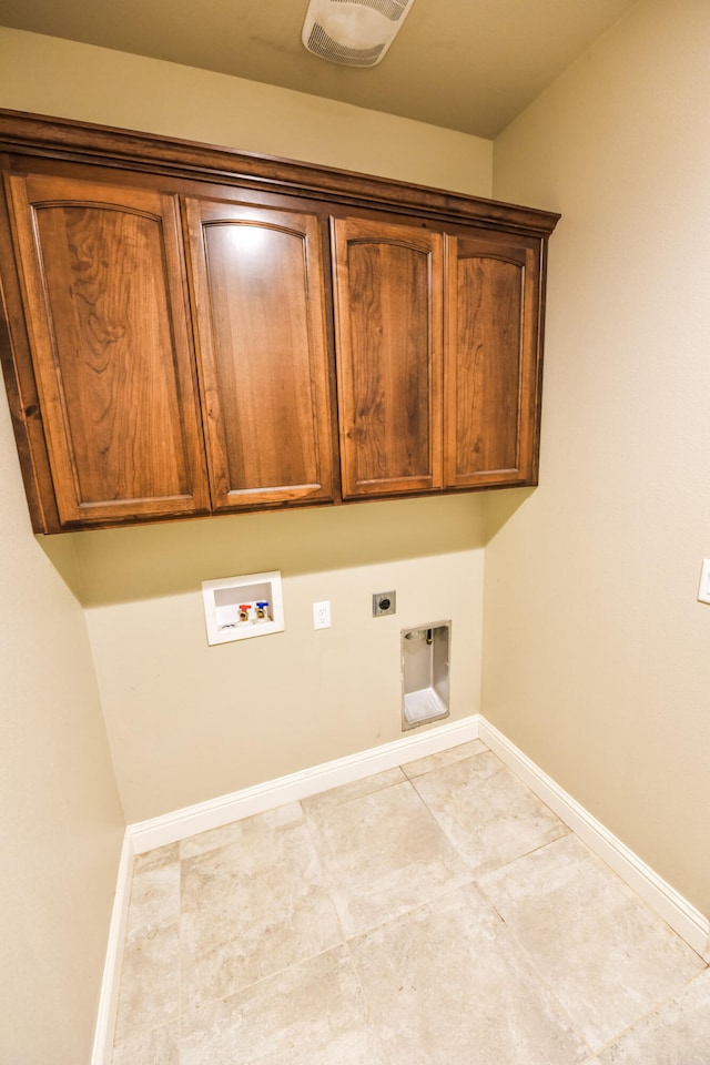 2876 Calaveras Ct, Redding, CA 96002 - laundry area featuring cabinet space, electric dryer hookup, washer hookup, baseboards, and tile patterned floors