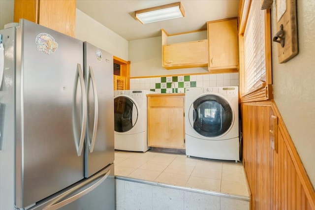 washroom with washing machine and clothes dryer and light tile patterned floors