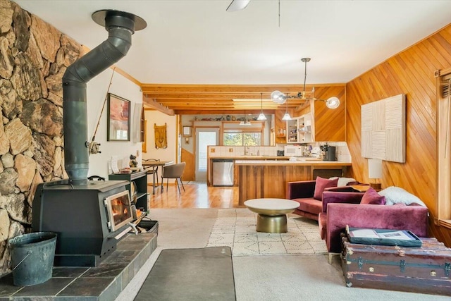 living area featuring a wood stove and wood walls