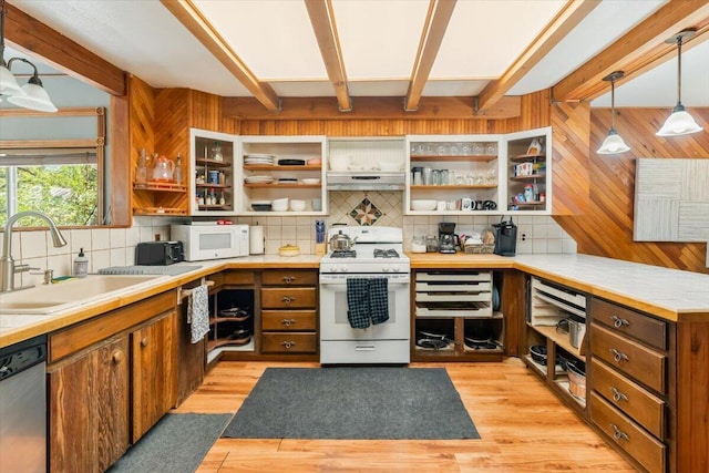 kitchen with under cabinet range hood, white appliances, a sink, open shelves, and backsplash