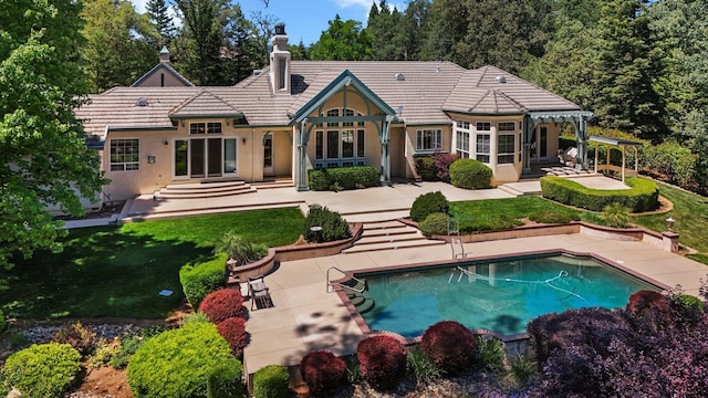 13365 Tierra Heights Rd, Redding, CA 96003 - rear view of house with a pergola, a lawn, a patio, stucco siding, and an outdoor pool