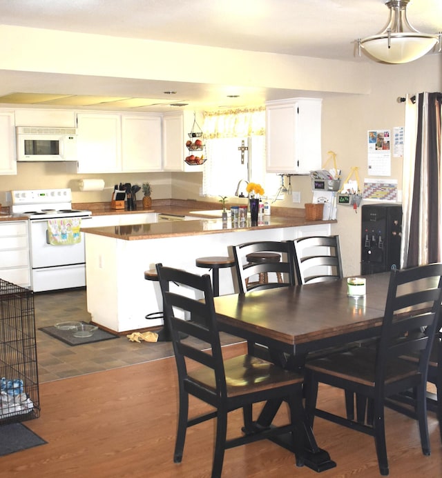 dining area with dark wood finished floors
