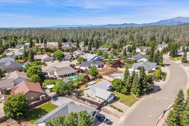 4217 Pendleton Ct, Shasta Lake, CA 96019 - aerial view of residential area featuring a heavily wooded area and mountains