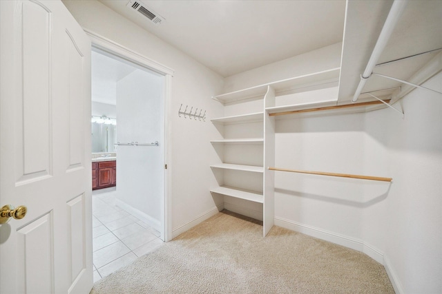 4217 Pendleton Ct, Shasta Lake, CA 96019 - walk in closet featuring light carpet and light tile patterned floors