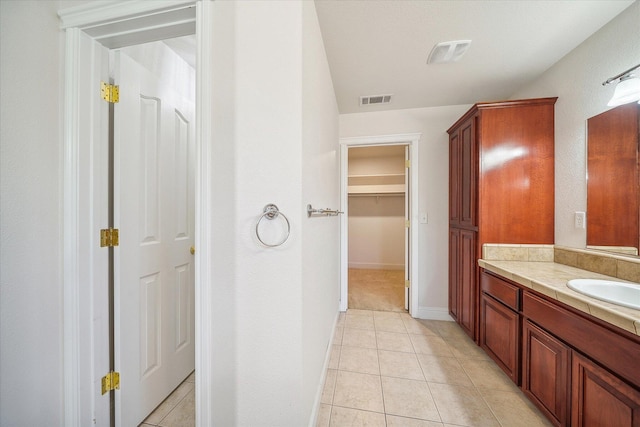4217 Pendleton Ct, Shasta Lake, CA 96019 - bathroom featuring vanity, tile patterned floors, baseboards, and a spacious closet