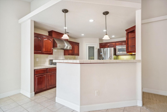 4217 Pendleton Ct, Shasta Lake, CA 96019 - kitchen featuring appliances with stainless steel finishes, wall chimney range hood, tile countertops, recessed lighting, and dark brown cabinets