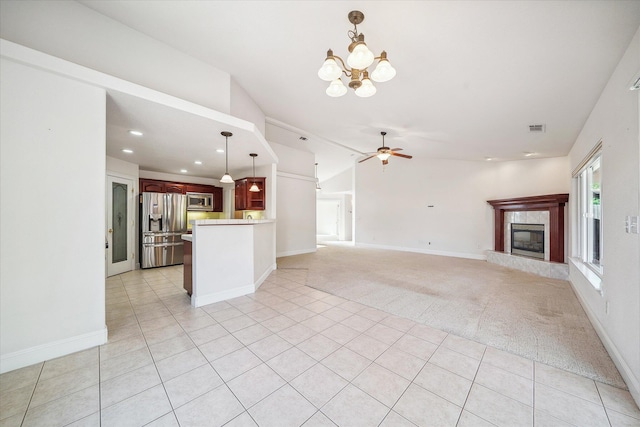 4217 Pendleton Ct, Shasta Lake, CA 96019 - unfurnished living room featuring vaulted ceiling, ceiling fan, a tiled fireplace, a chandelier, and recessed lighting