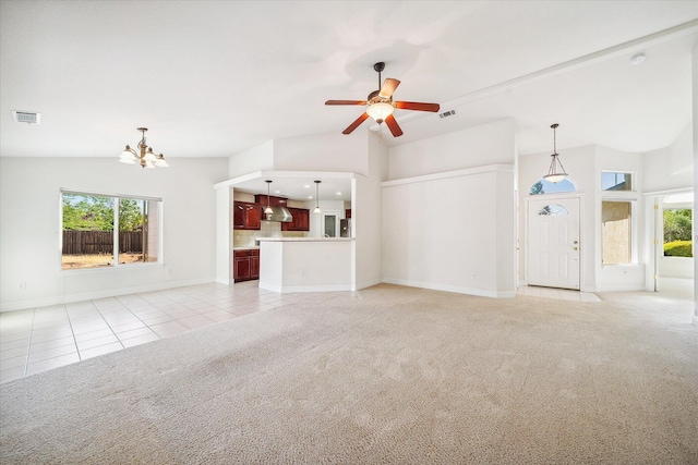 4217 Pendleton Ct, Shasta Lake, CA 96019 - unfurnished living room with light carpet, light tile patterned flooring, healthy amount of natural light, a chandelier, and high vaulted ceiling
