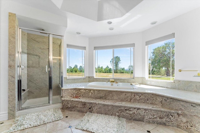 full bath featuring a stall shower, tile patterned flooring, and a garden tub